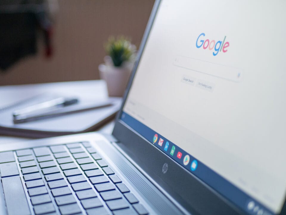 A laptop showcasing the Google search homepage